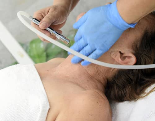 a woman in the clinic receives Mesotherapy Facial Rejuvenation Treatment