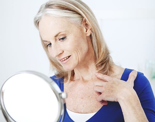 An aged woman prepares to restore the Aging Neck and Decolletage
