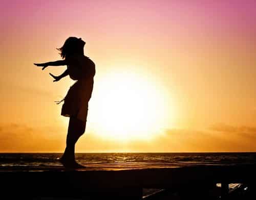 silhouette of a woman with the sunset in the background