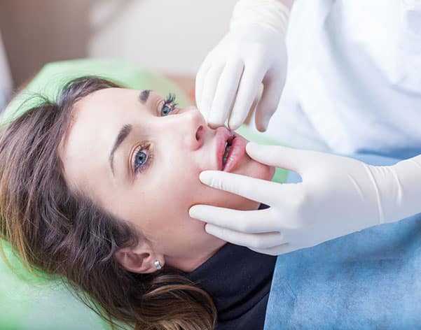 A doctor prepares a woman's lips for Successful Rejuvenation