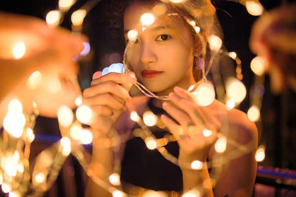 the face of a beautiful girl after using the Restylane lyft is surrounded by lights