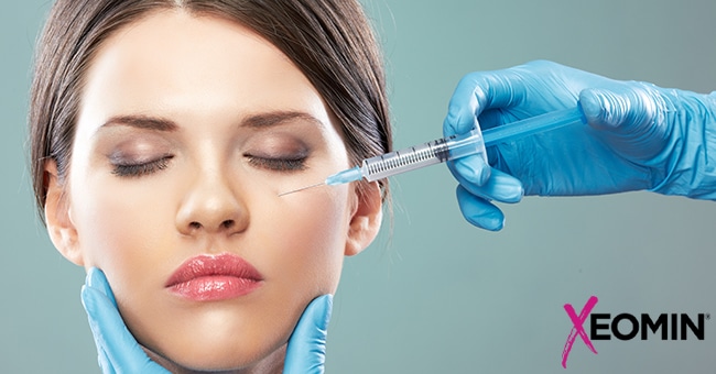 A woman receives a Xeomin injection under her left eye