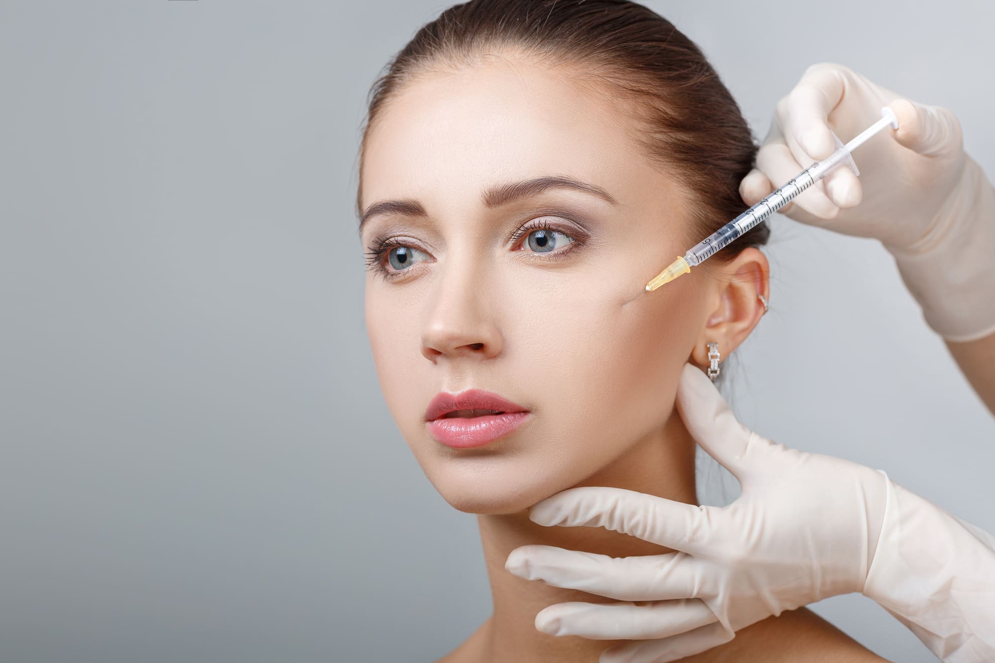 woman getting a restylane injection in her cheek