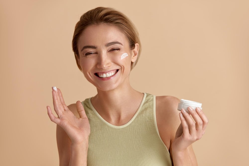A woman applies Calecim Cream