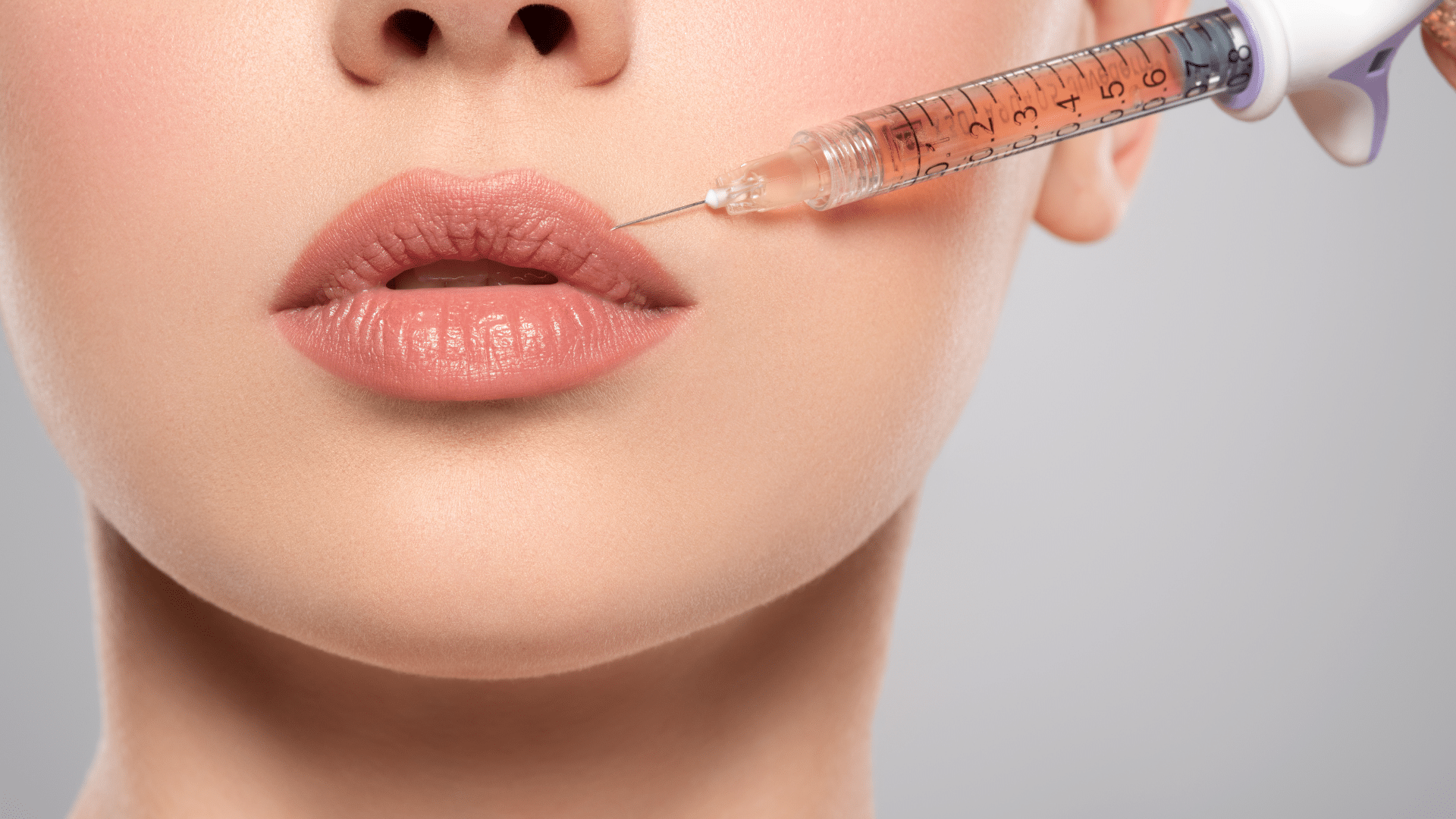 Woman getting lip injections.