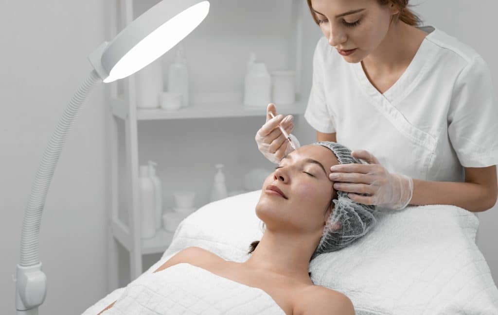 beautician doing filler injection female client