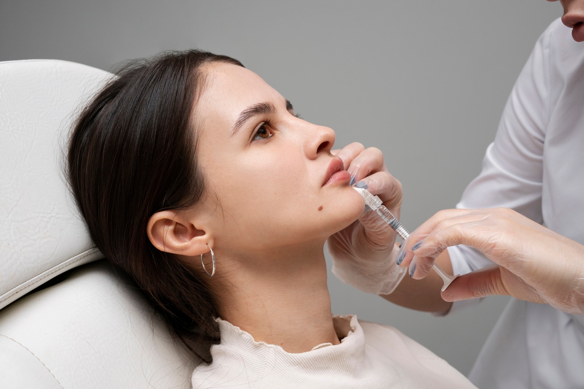 A healthcare professional carefully injects Dysport into the masseter muscle.