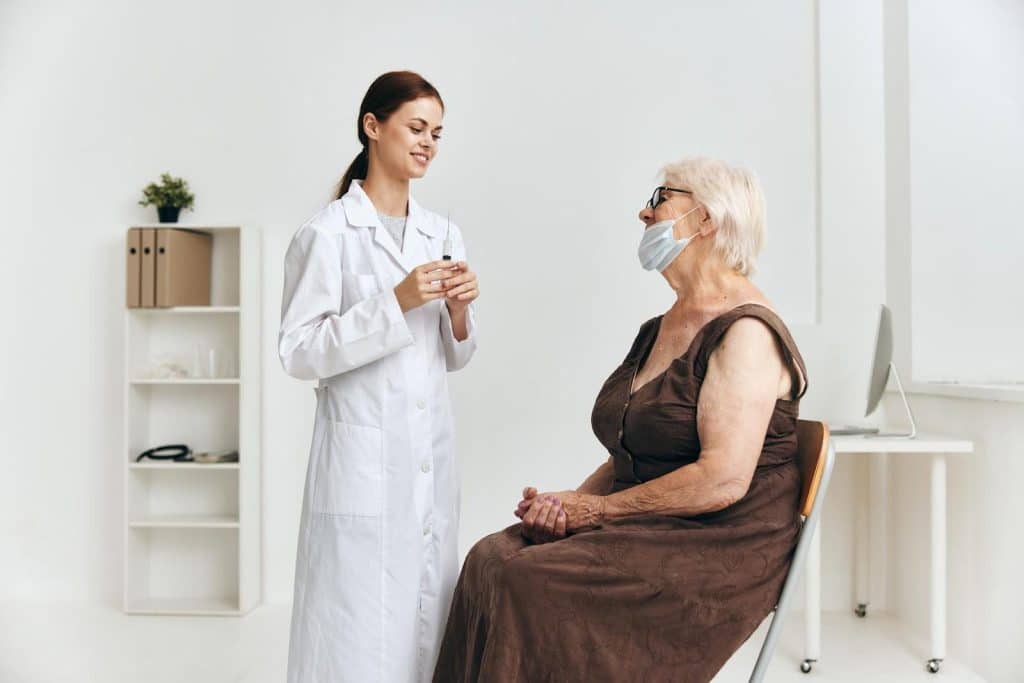 A healthcare professional briefs a senior patient about using Dysport for eyebrow lift procedure.