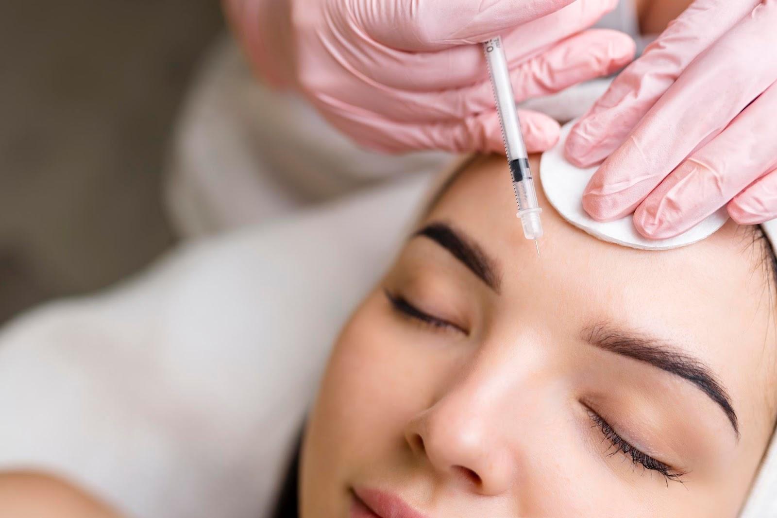 A woman in an aesthetic clinic receives Dysport injection to lift her eyebrows.