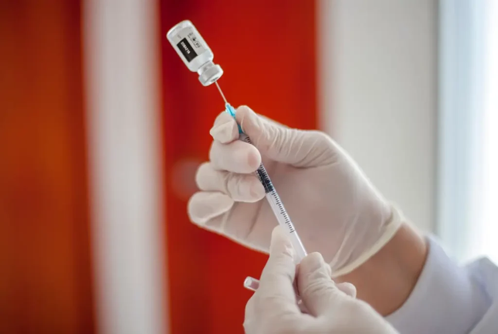 doctor fills the syringe with the treatment