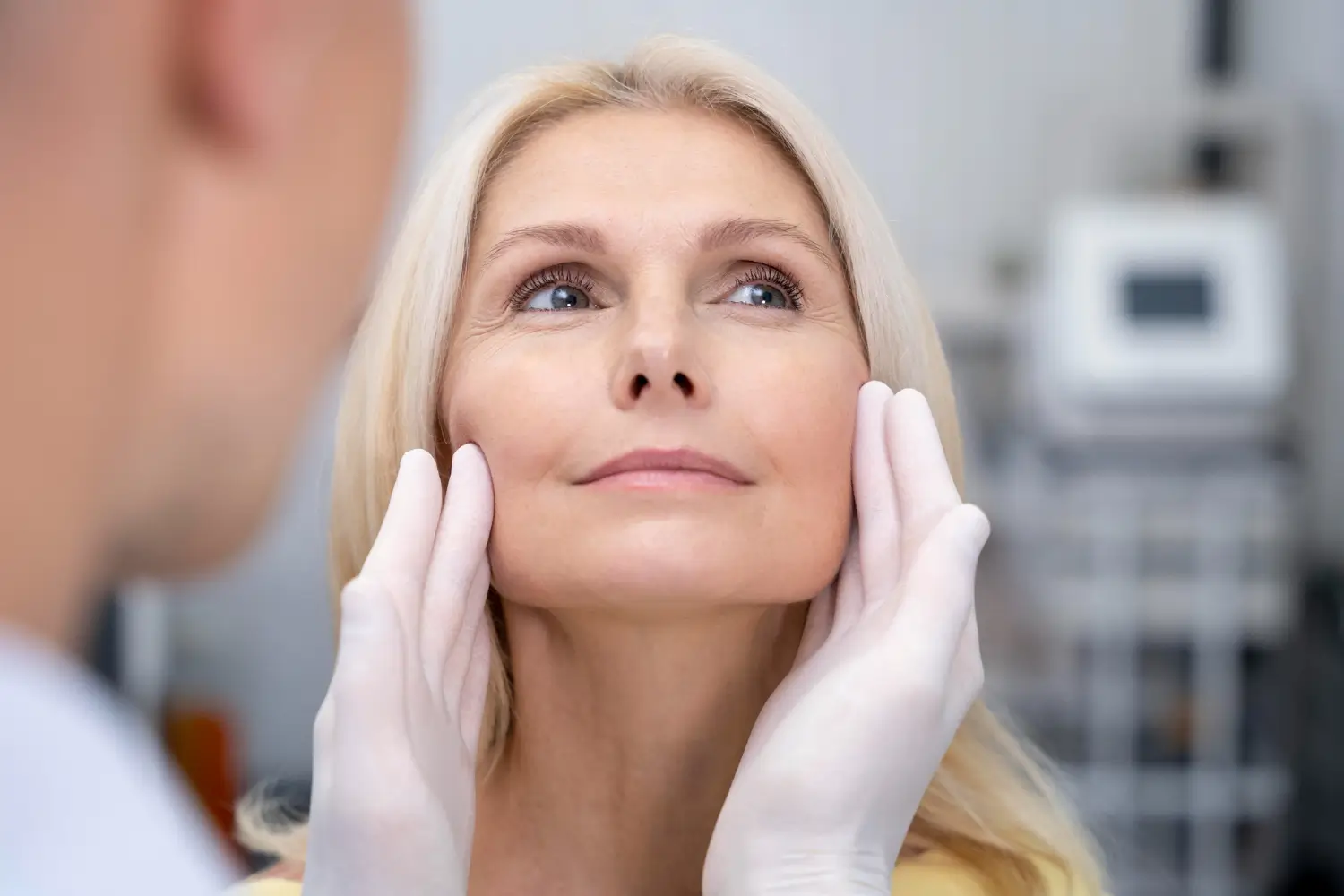 patient comfortably lets the derma check on her face