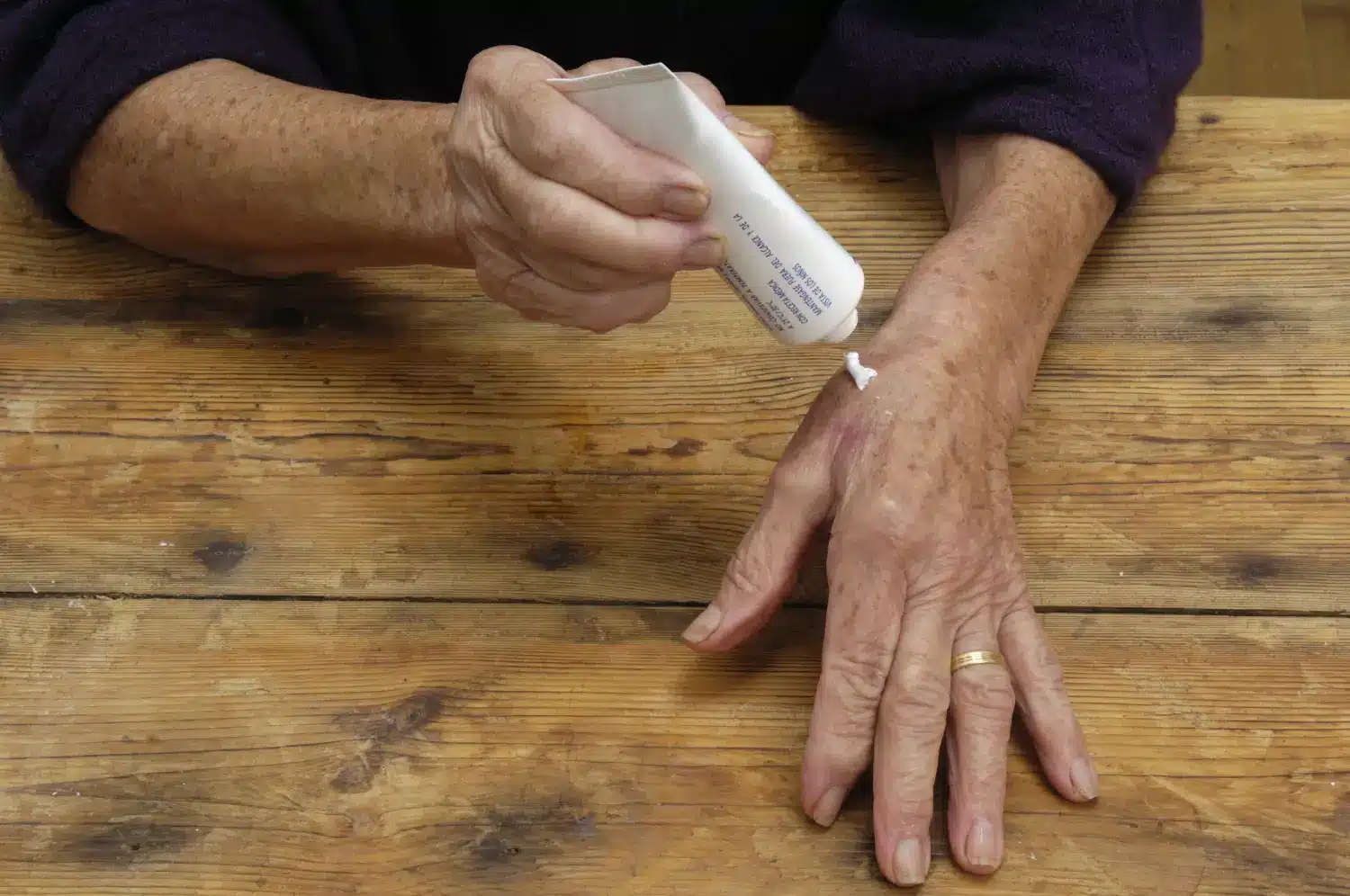 Applying cream on hand.