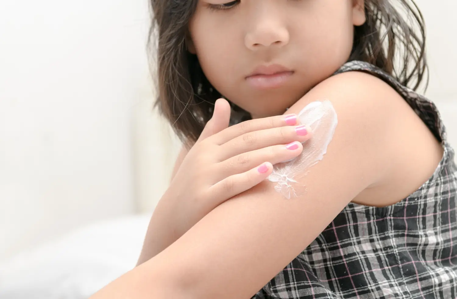putting cream on arm