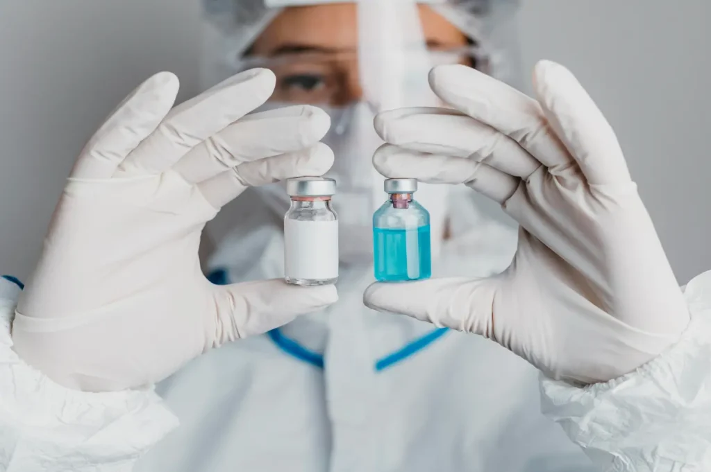 the doctor is checking the difference in the two vials