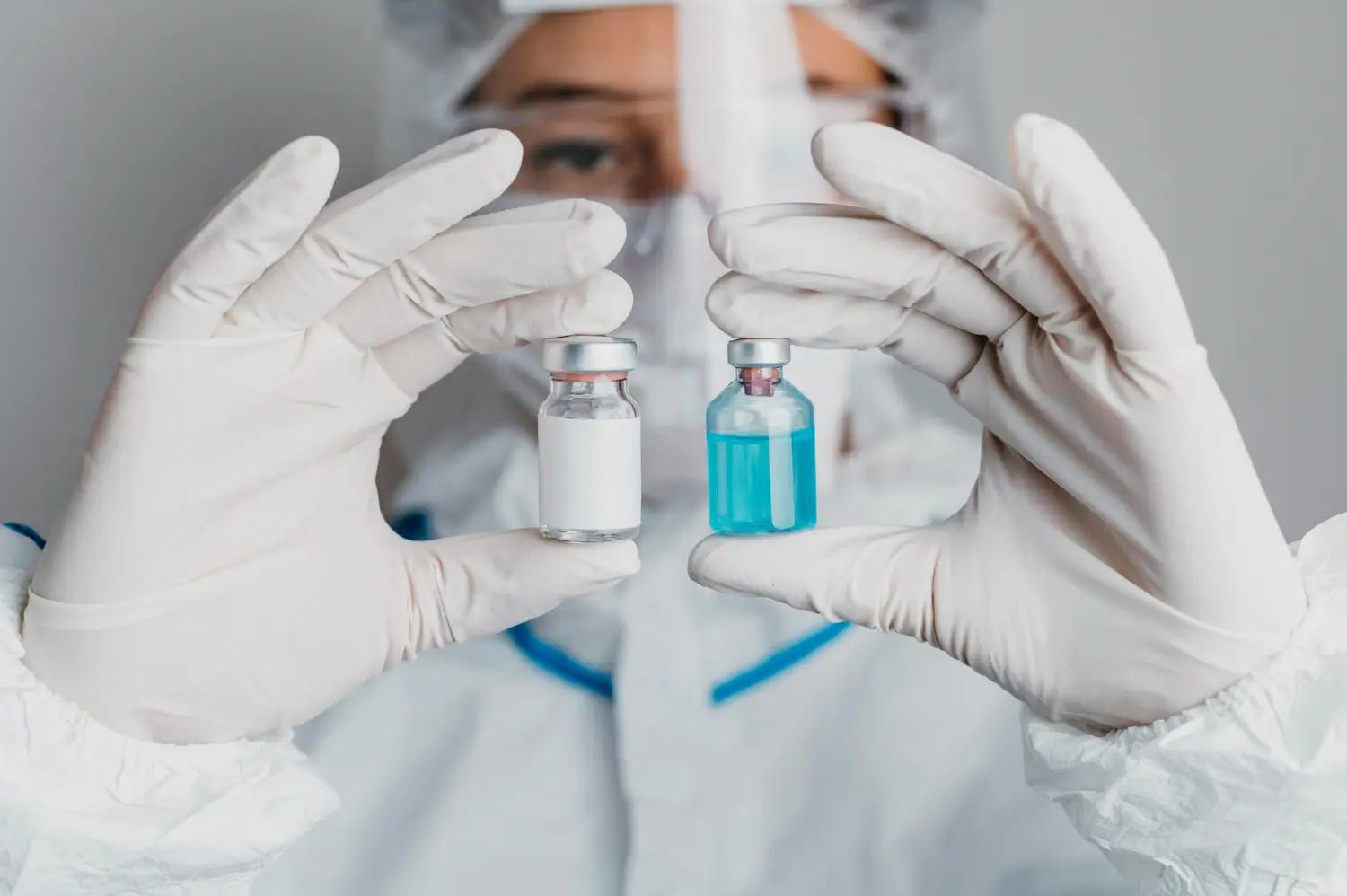 the doctor is checking the difference in the two vials