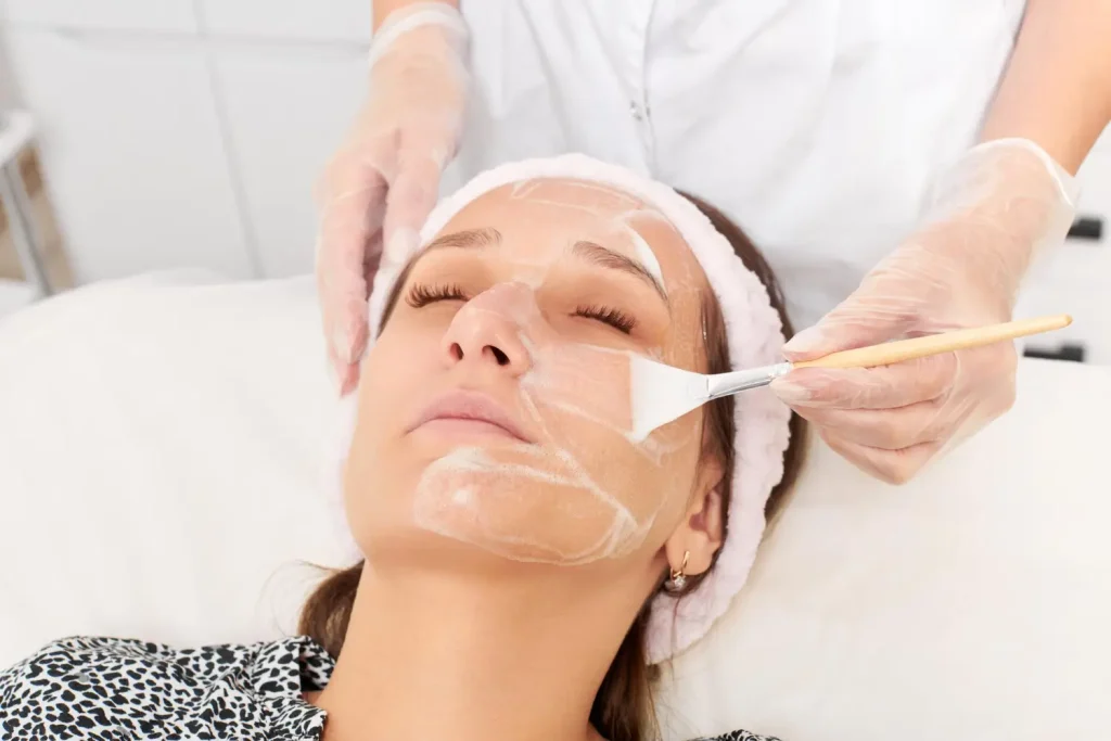 Patient receives a chemical peel or facial treatment like BioRePeel from an aesthetician for professional skincare. 