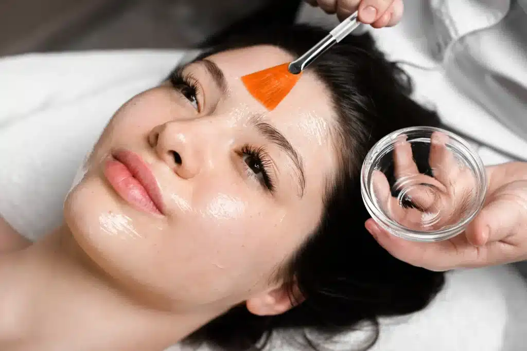 Young woman receiving a skin peeling treatment, probably BioRePeel or other checmical peel treatment.