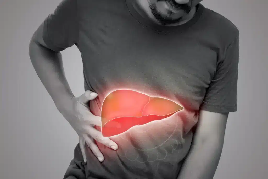 Man clutching his abdomen in pain, maybe due to the side effect of an injectable treatment like Cimzia.