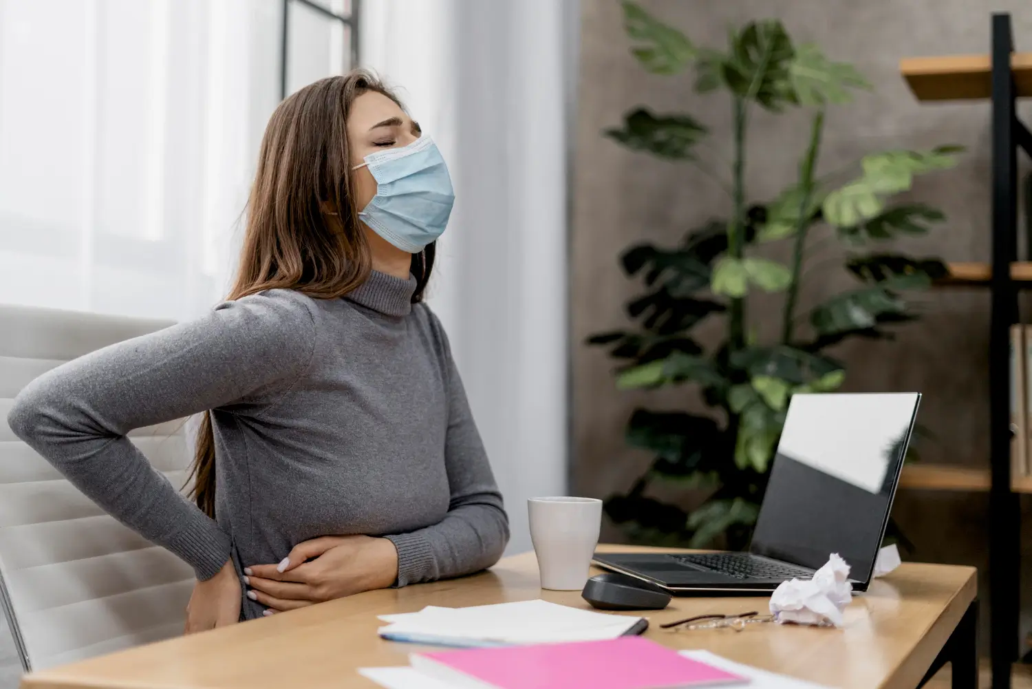 Woman is suffering from back pain, maybe as a side effect of the weight loss treatment like Wegovy she's taking.