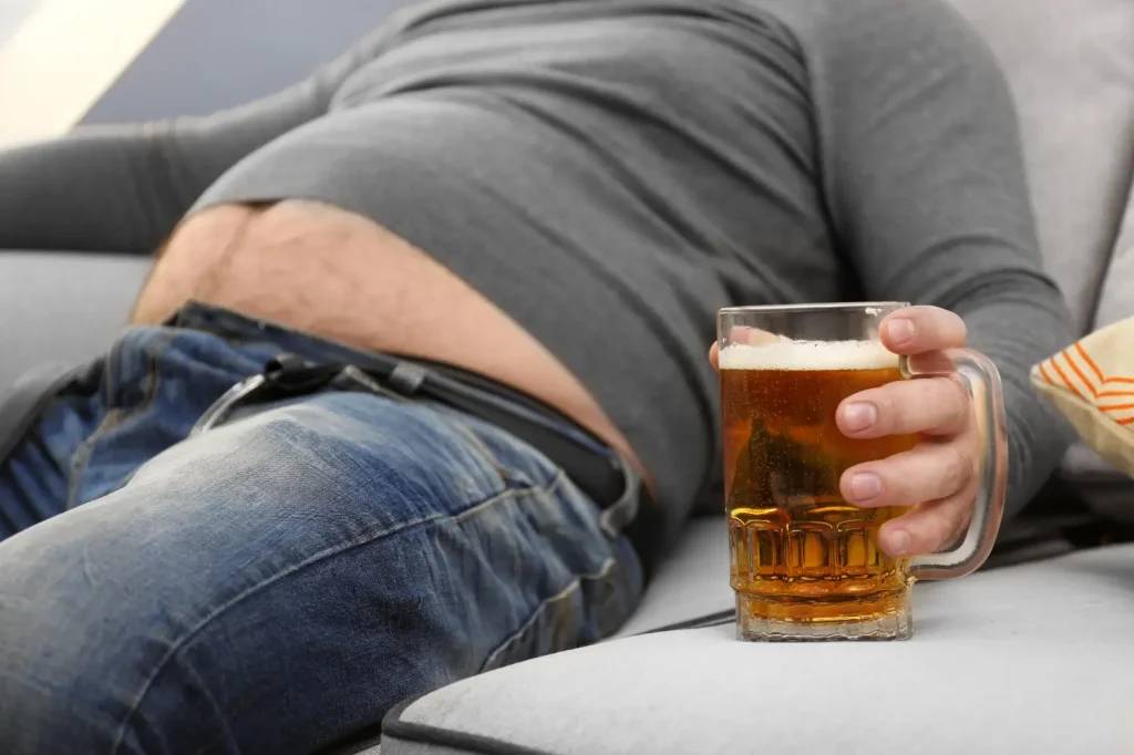 A man enjoys drinking alcohol while not minding his weight.