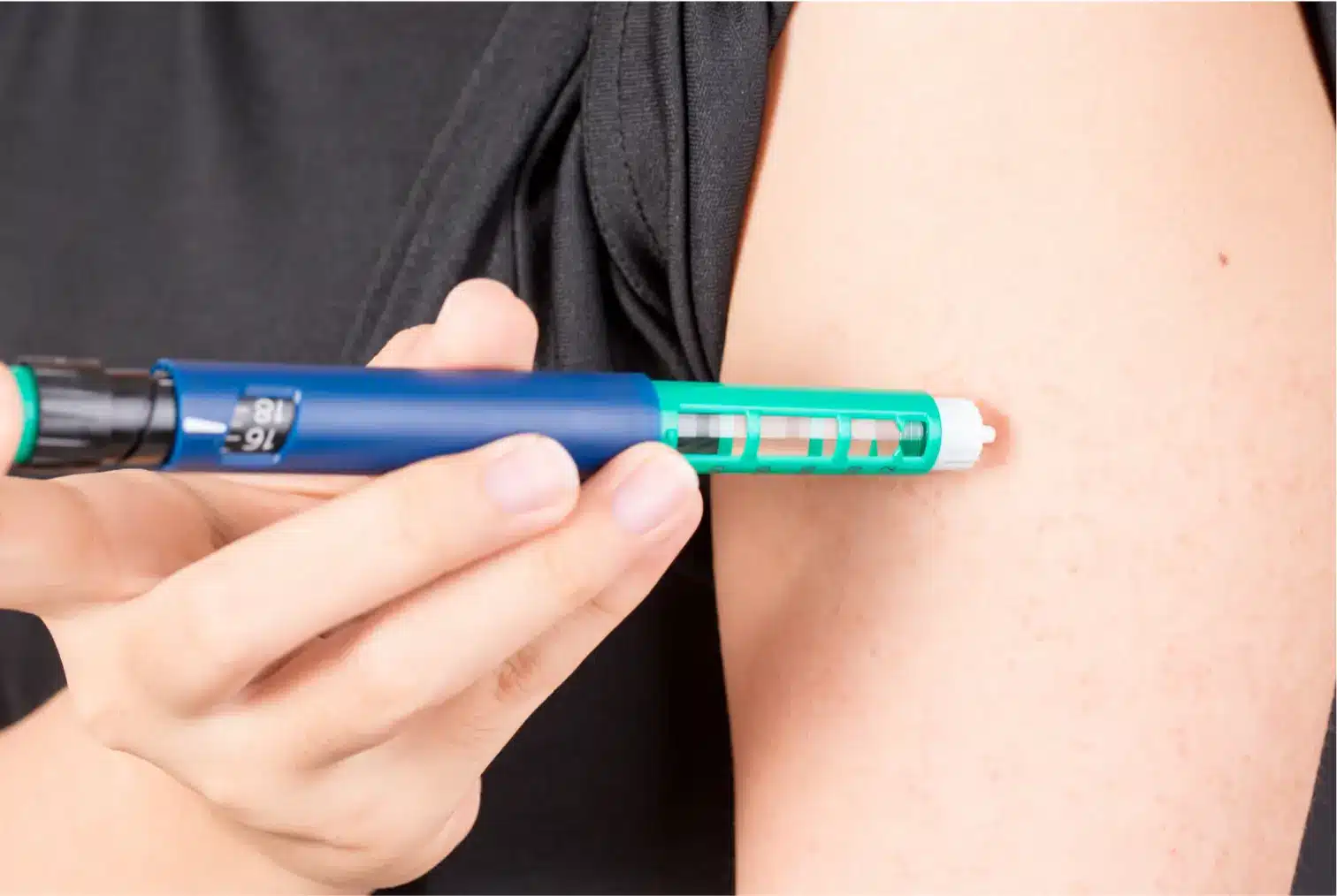He injects the treatment pen on his arm as part of his weight loss journey.