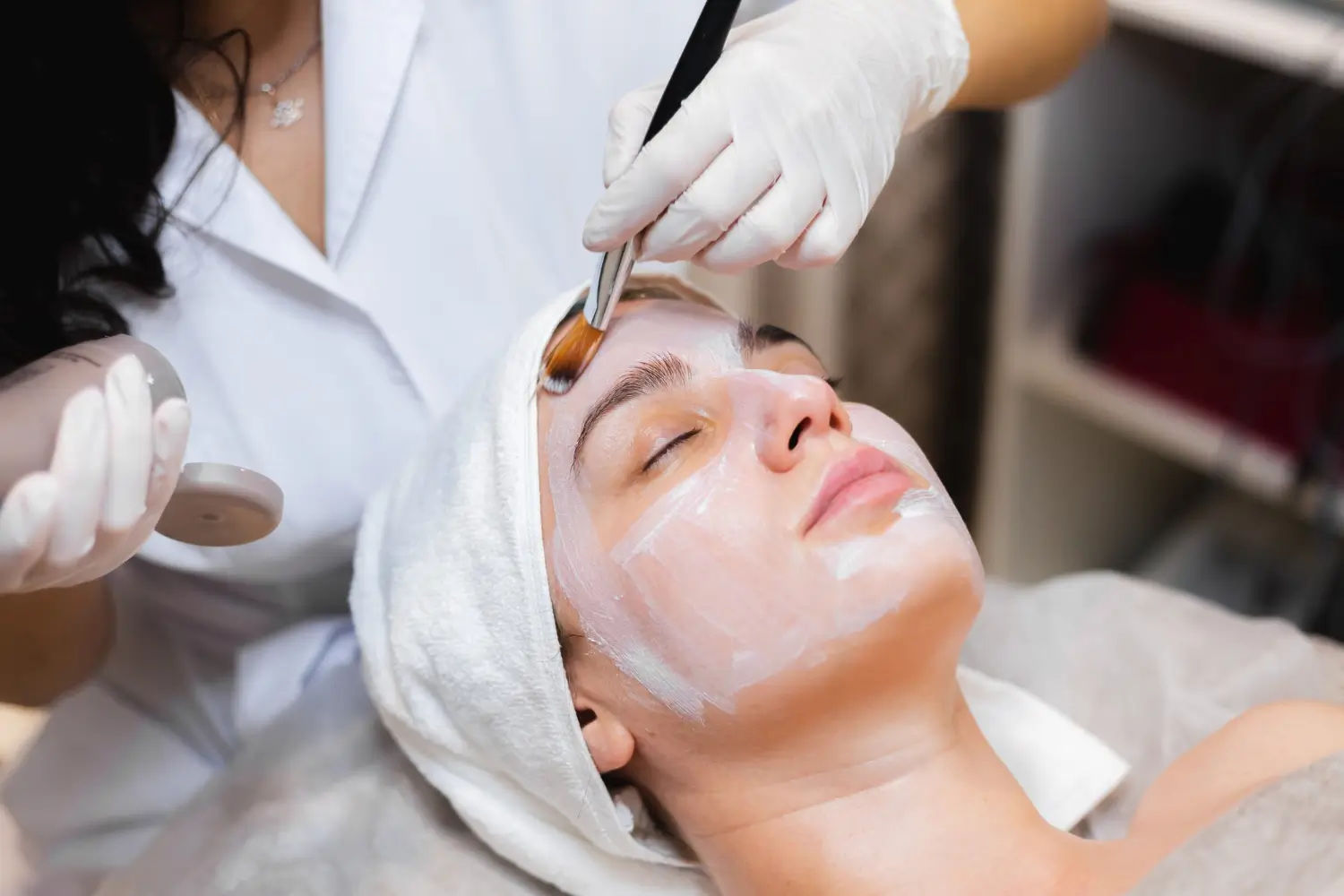 Aesthetician applies BioRePeel peeling solution for glowing results.