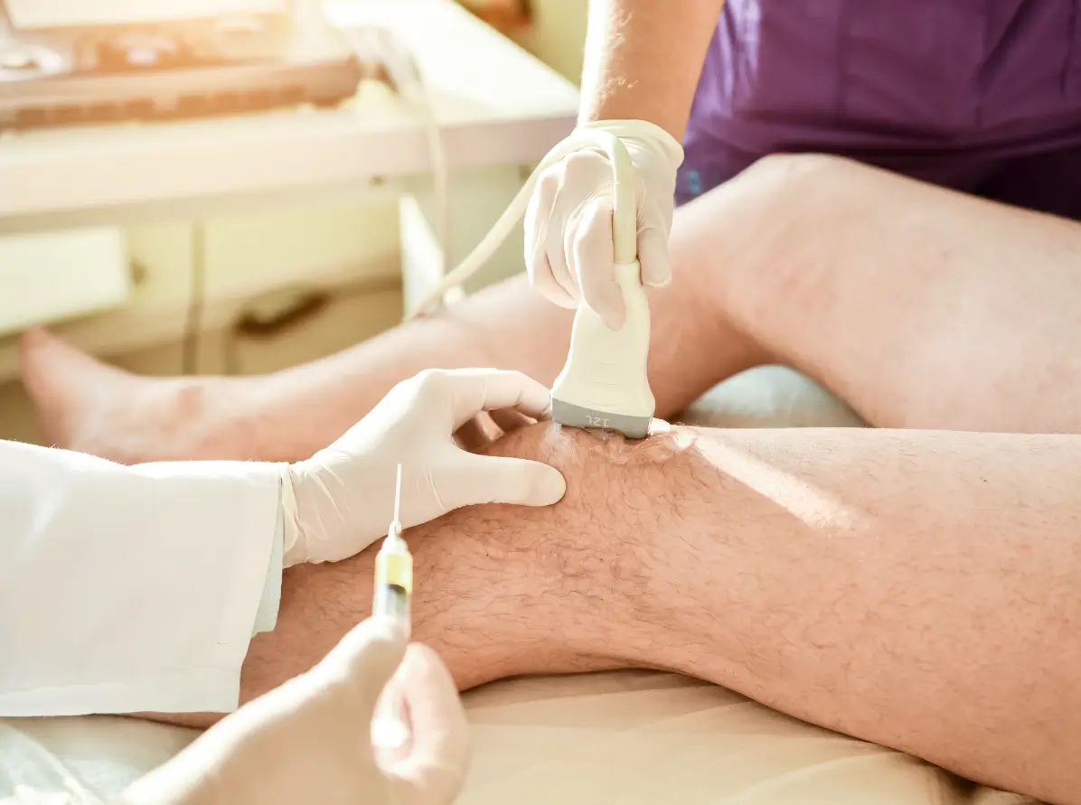 Expert performing ultrasound-guided knee injection for pain relief and precise joint treatment.