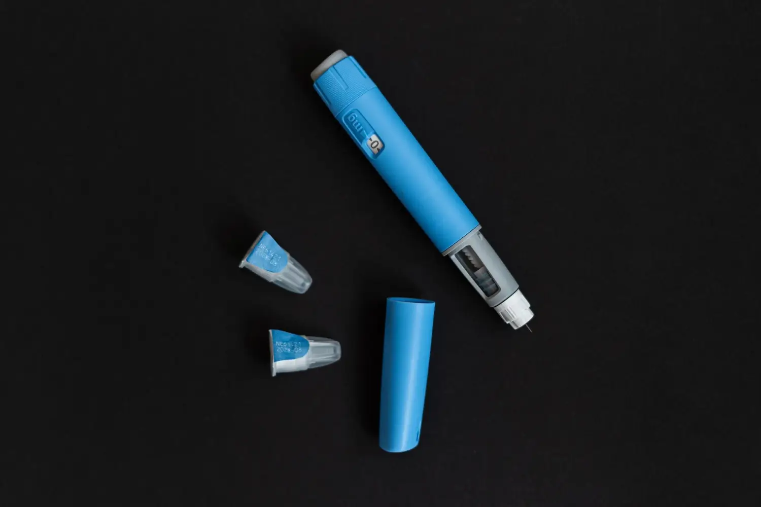 An insulin injectable pen that waits to be used is on the table.