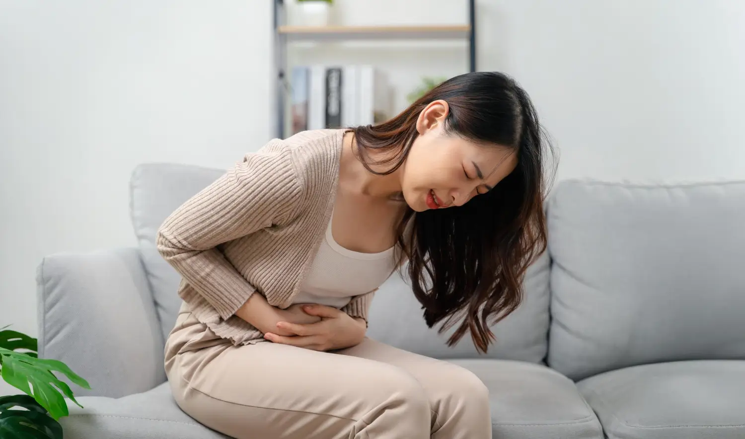 Woman suffers from tummy pain and needs some help.