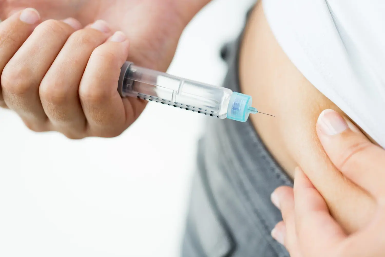 Patient self-injecting insulin medication like Mounjaro for diabetes control.