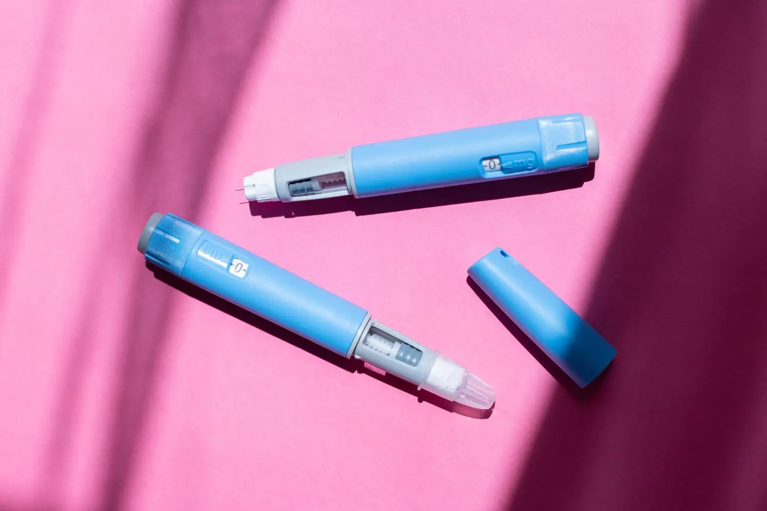 two insulin pens placed on the table for the patient to use.