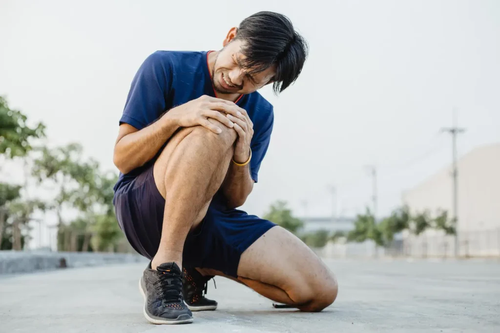 Man experiencing knee pain while exercising, probably needs a shot of Orthovisc or other viscosupplement.