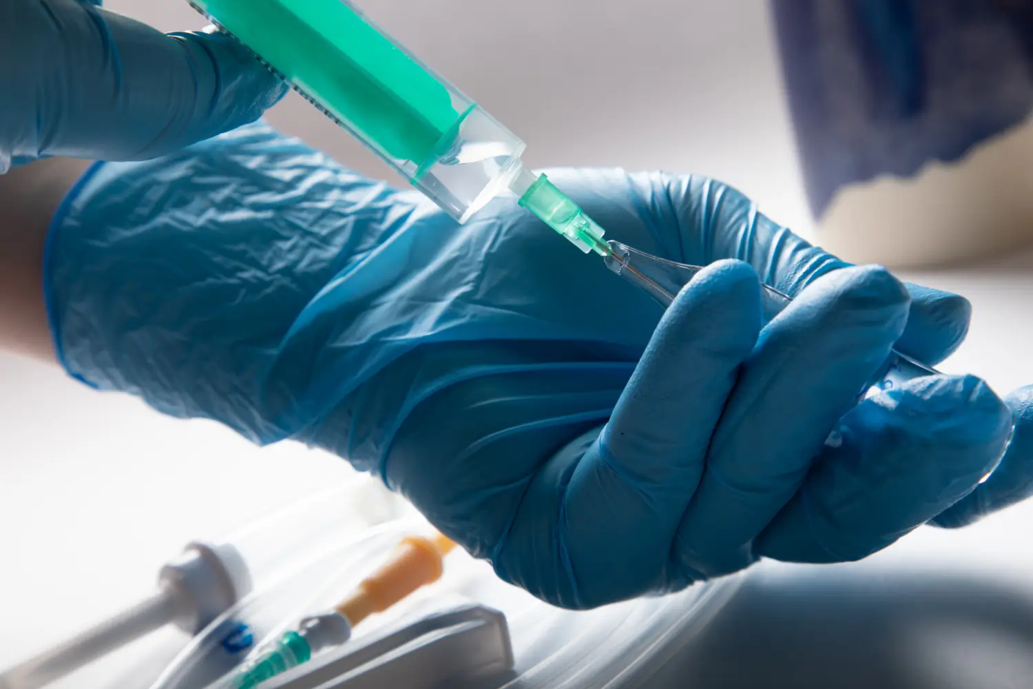 Doctor preparing a syringe for injection. 