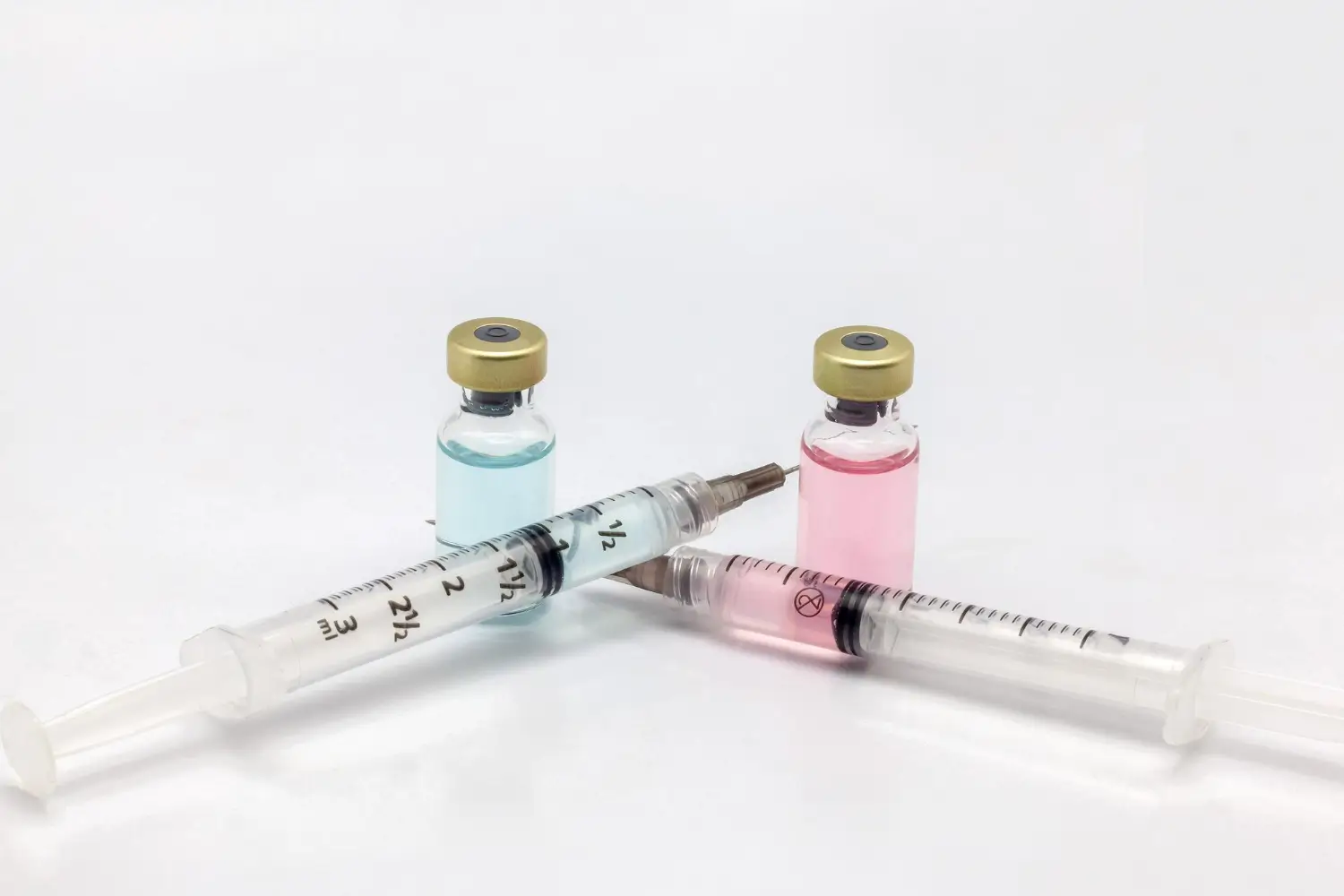 Colorful medication vials and syringes illustrate modern medical treatments for various health conditions.