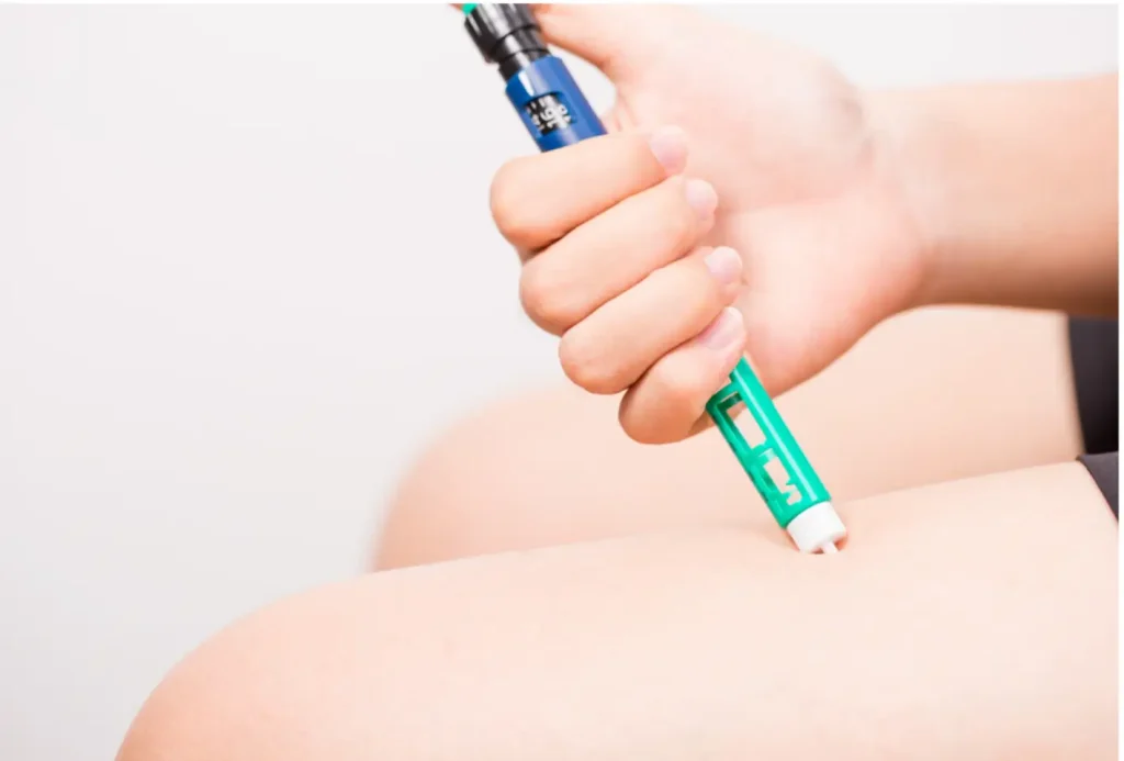 Patient self-injecting doiabetes treatment on himself, maybe Mounjaro or other injectable pens.