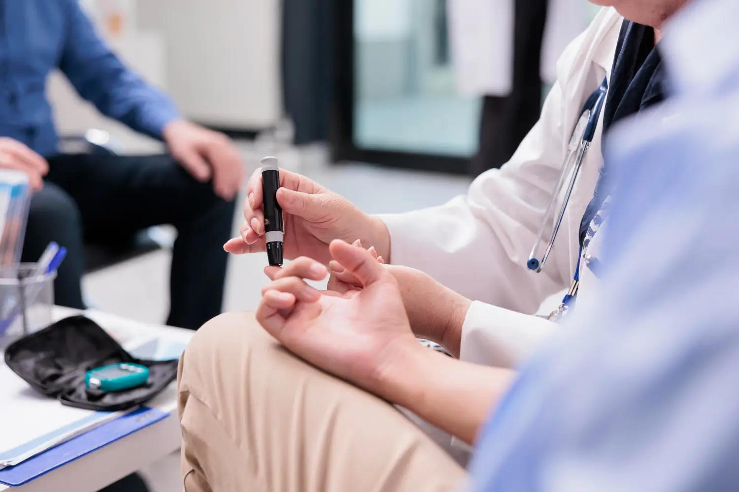 Doctor checks the patient's blood sugar level for diagnosis and monitoring.
