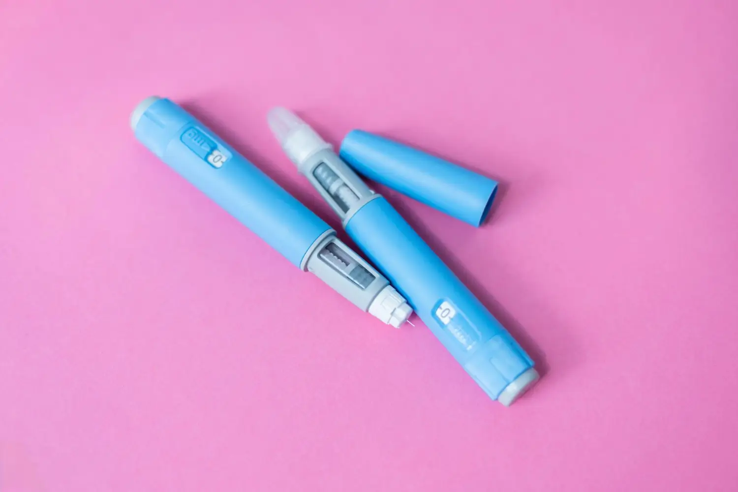 Two blue pre-filled injection pens for managing diabetes or other chronic conditions.